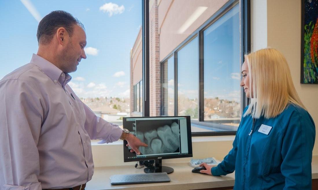 Doctor Examining X-ray pediatric dentist highlands ranch | Dr. Sierk examining x-ray