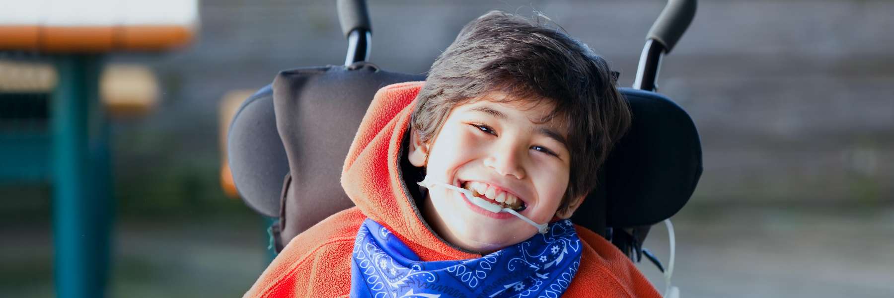 Boy in wheelchair laughing | Highlands Ranch Dentist